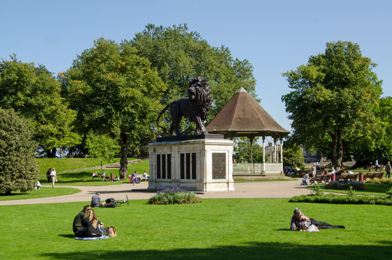 People enjoying the sunshine in Forbury Gardens in Reading, Berkshire
